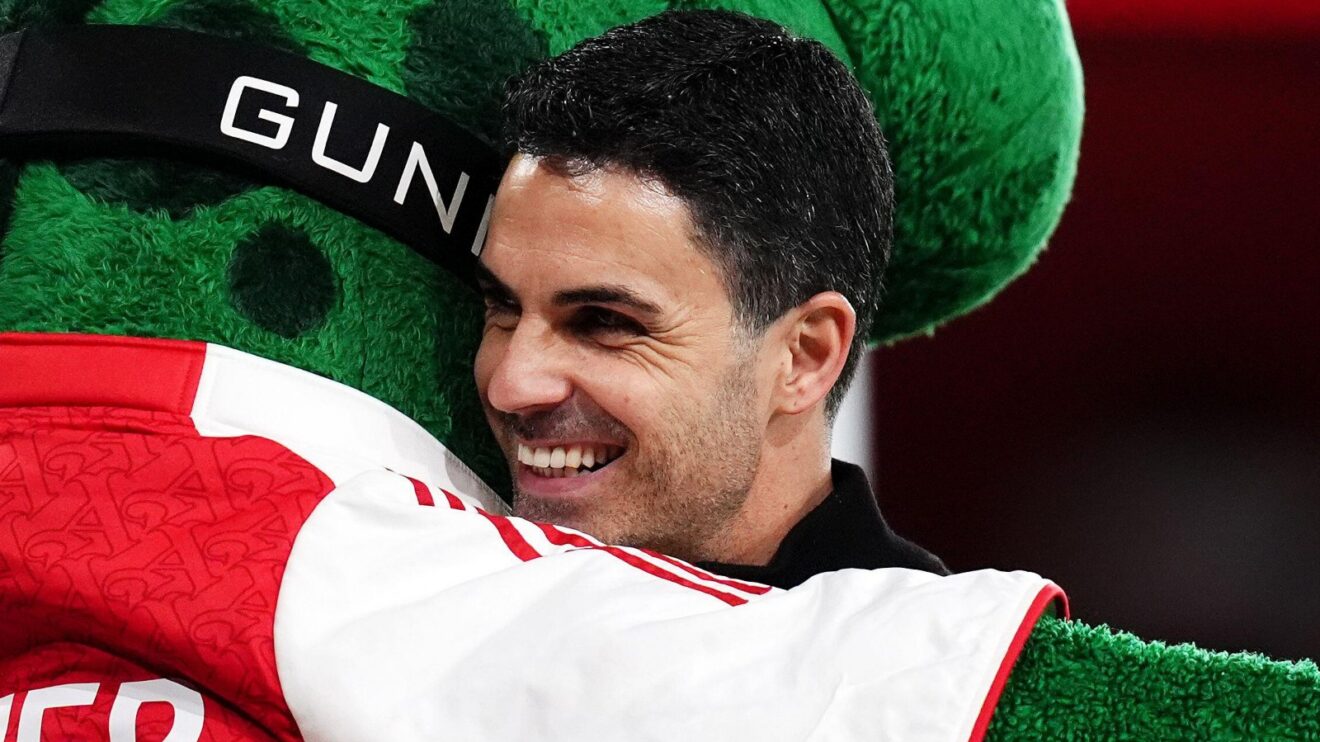 Arsenal manager Mikel Arteta embraces Gunnersaurus