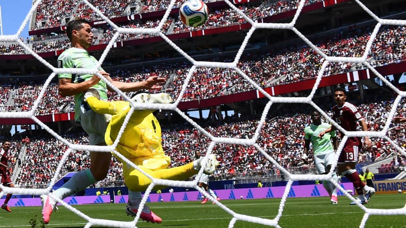 Switzerland player Remo Freuler is fouled by Qatar keeper Mahmoud Abunada at the 2026 World Cup