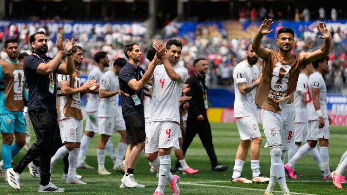 Iran players applaud fans