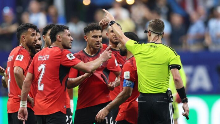 Egypt players surround referee