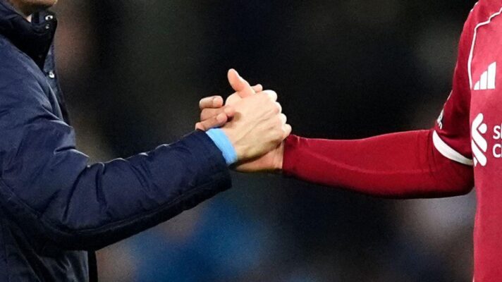 Manchester City and Liverpool players shake hands