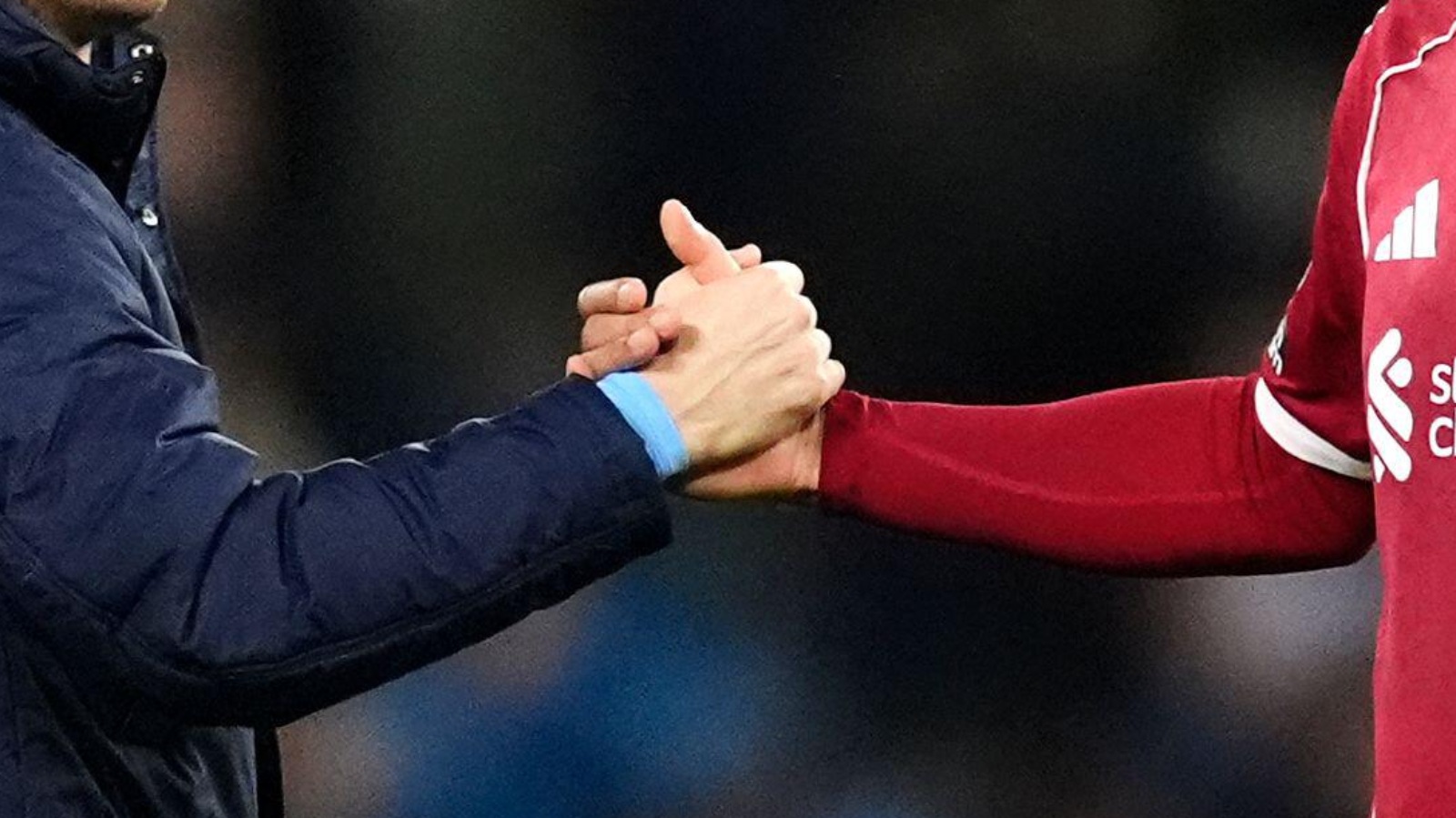 Manchester City and Liverpool players shake hands