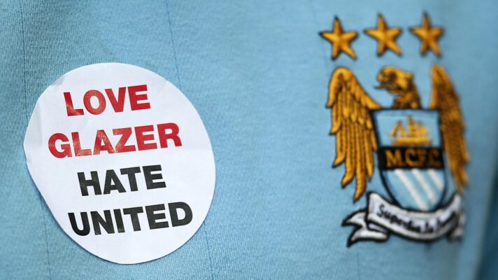 A Manchester City shirt featuring the badge and support for the Glazers