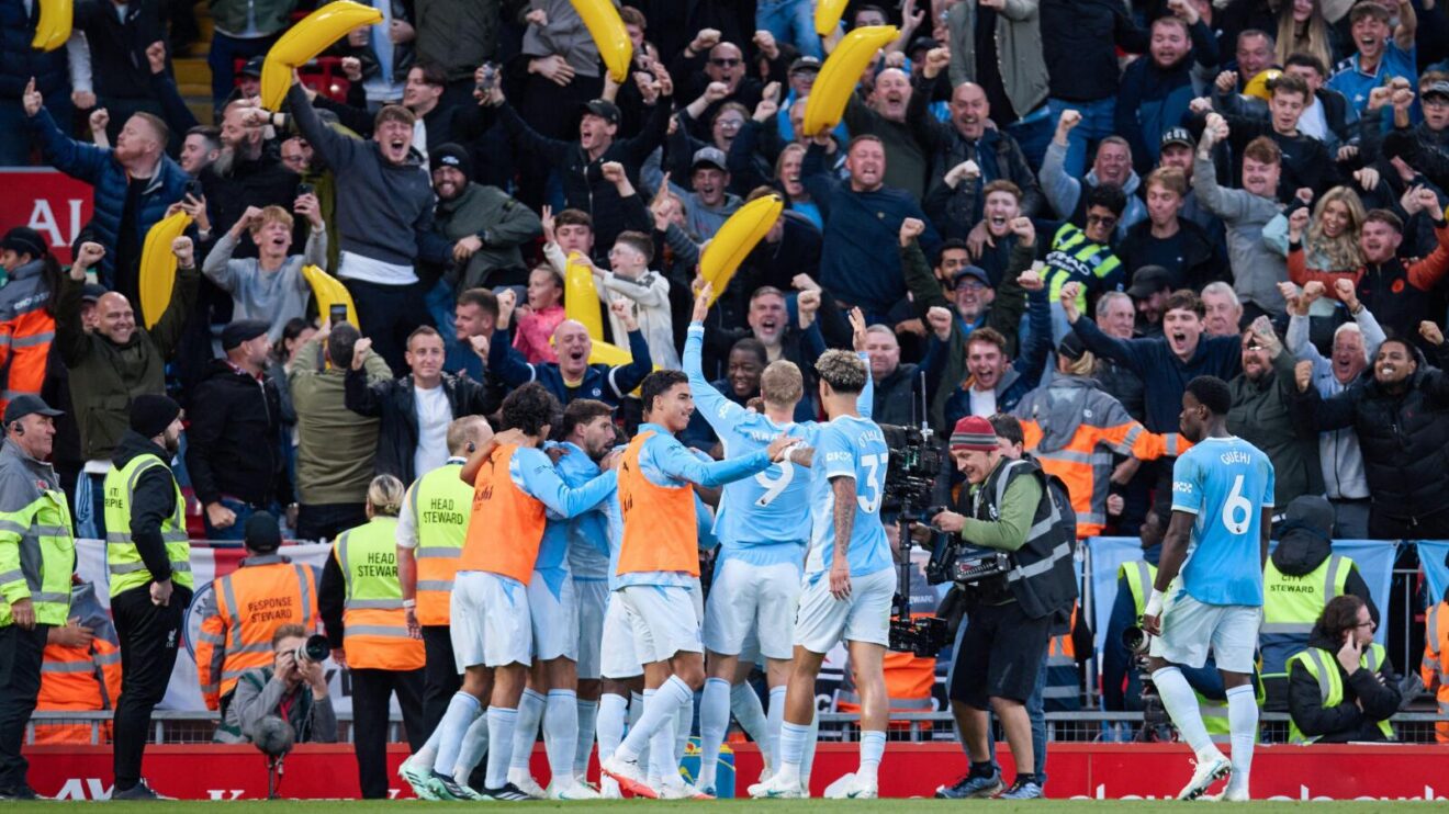 Manchester City player and fans celebrate their 3-0 win at Liverpool